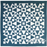 Geometric patterned quilt in teal blue and white from Art East Quilting Propeller Quilt Pattern
