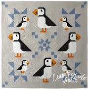 Puffin Star Quilt pattern with eight puffins and blue geometric accents by Art East Quilting