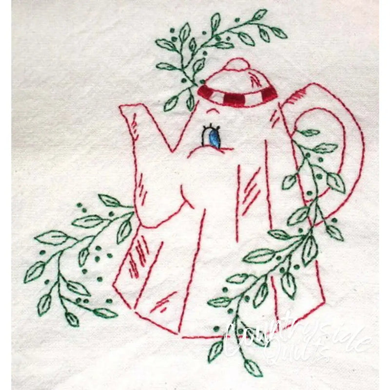 Red embroidered teapot surrounded by green leaves from Aunt Martha’s animated crockery