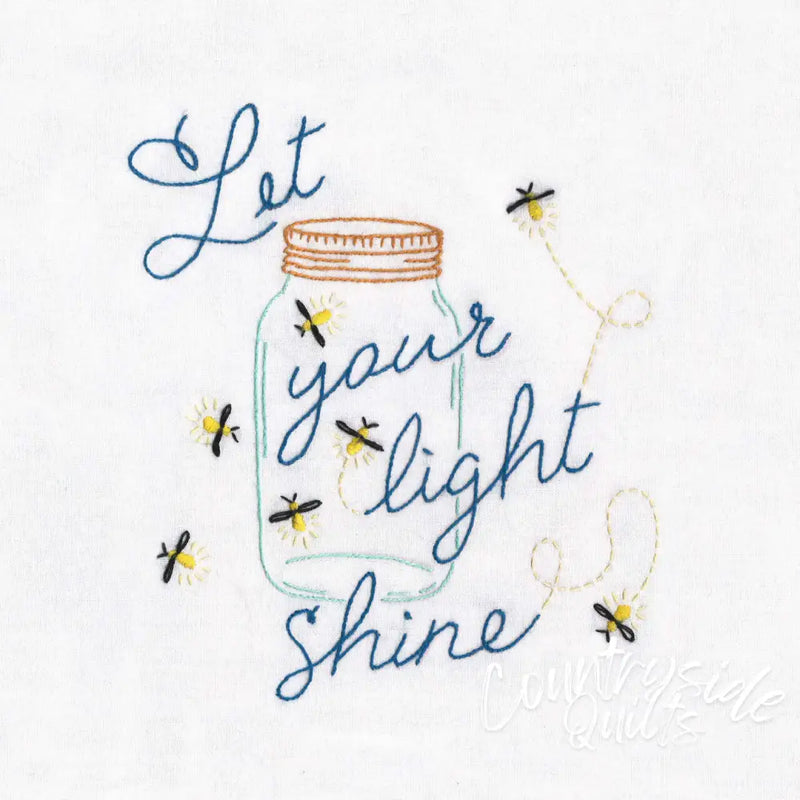 Mason jar with Let your light shine design by Aunt Martha’s features blue fireflies embroidery