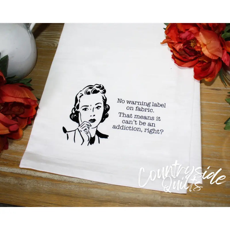 White tea towel featuring retro illustration and humorous washing label text from Aunt Martha’s Dirty Laundry