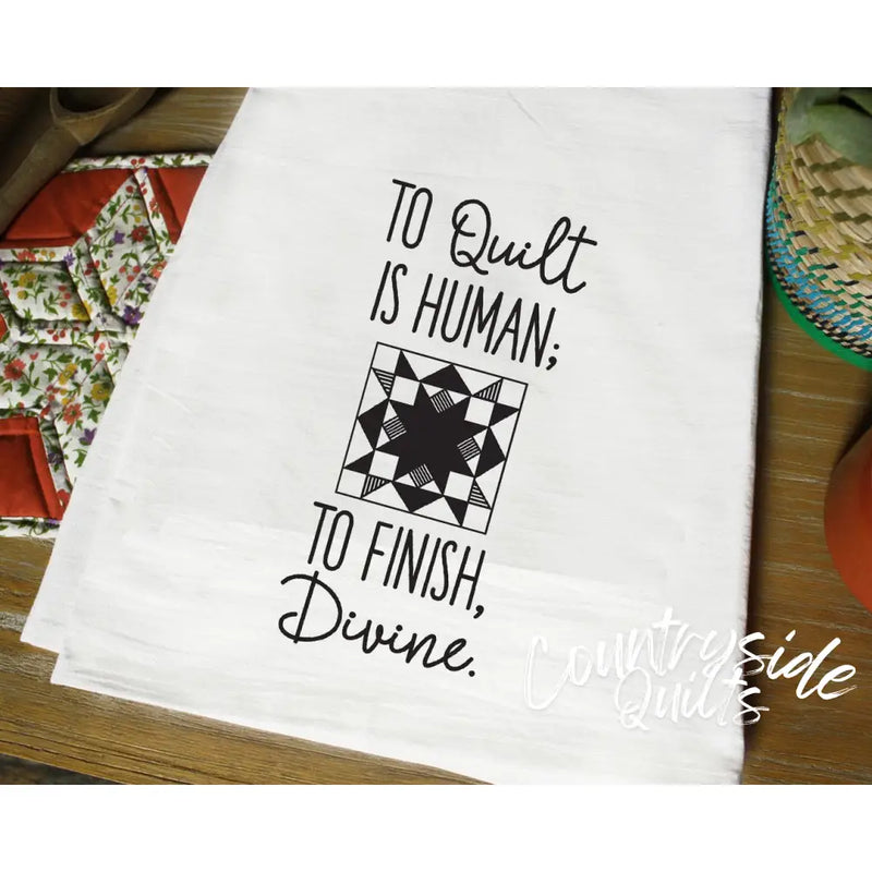 White tea towel with black text and quilting pattern from Aunt Martha’s Dirty Laundry