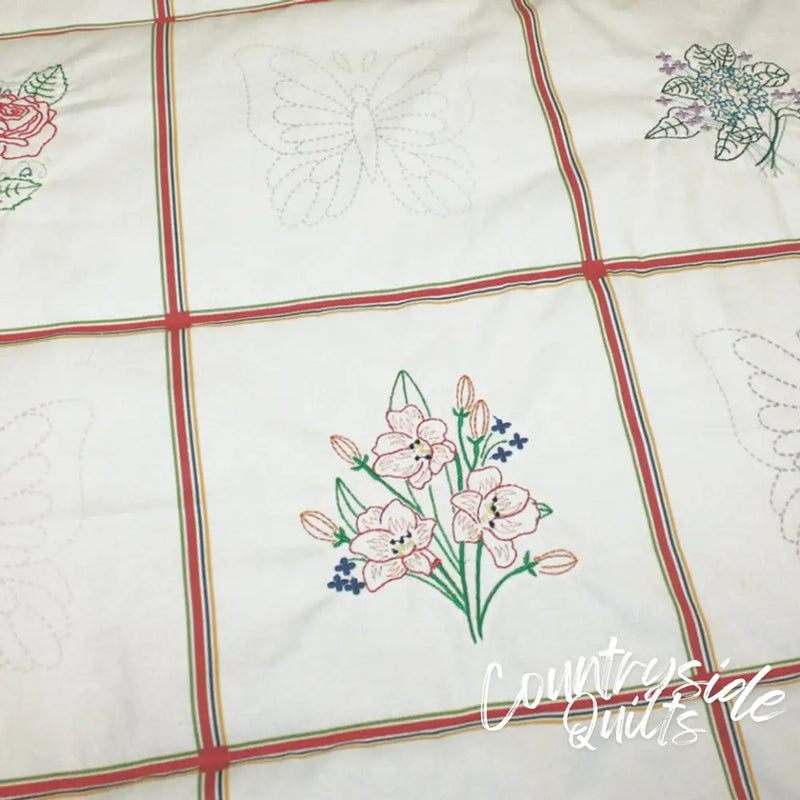 Embroidered floral bouquet with pink tulips on Aunt Martha’s Quilting Fabric multi stripe print