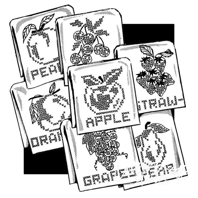 Cross-stitched fancy fruit designs on fabric squares for Aunt Martha’s® countryside quilts