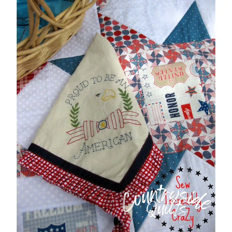 Patriotic embroidered fabric by Aunt Martha’s featuring Proud to be American text