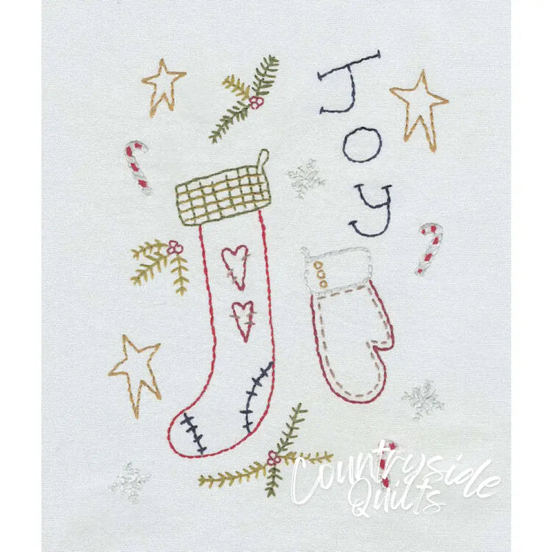 Hand-embroidered Christmas stocking and mitten from Aunt Martha’s Primitive Christmas collection