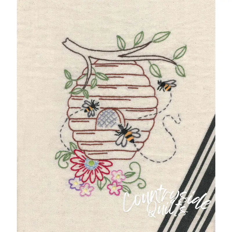 Embroidered beehive with bees and flowers from Aunt Martha’s Buzzing Bees pattern