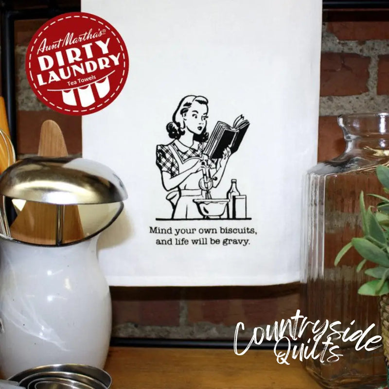 Retro wall art depicting Aunt Martha’s Dirty Laundry featuring the phrase Mind Your Own Biscuits and Life Will Be Gravy