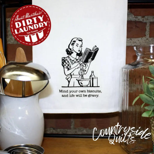 Retro wall art depicting Aunt Martha’s Dirty Laundry featuring the phrase Mind Your Own Biscuits and Life Will Be Gravy