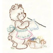Embroidered bear doing laundry on Aunt Martha’s® Lotsa Bears quilt in countryside quilts style