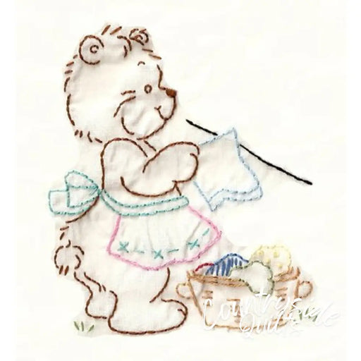 Embroidered bear doing laundry on Aunt Martha’s® Lotsa Bears quilt in countryside quilts style