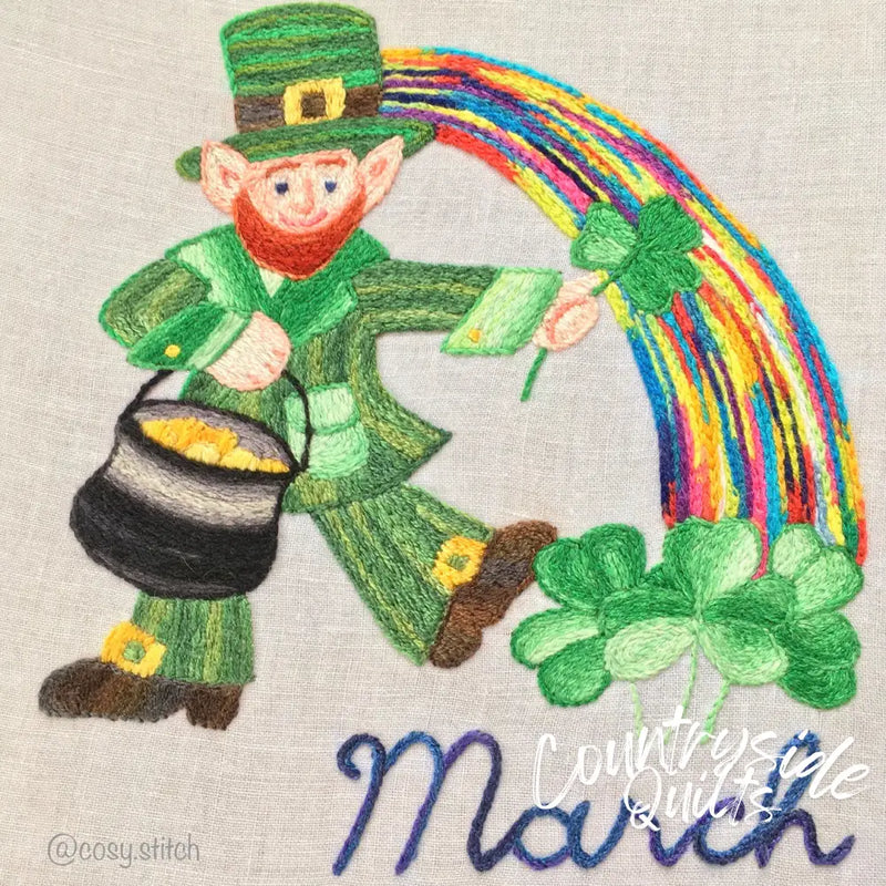 Embroidered leprechaun with rainbow and pot of gold on Aunt Martha’s® Monthly Madness quilt